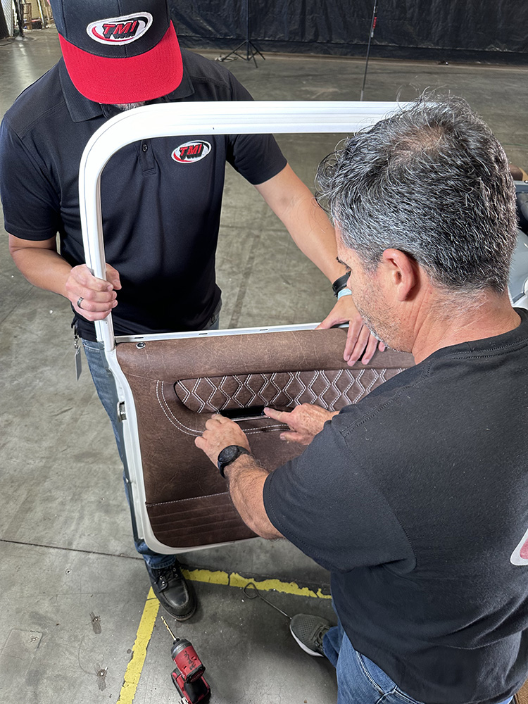 15 Brown leather door panel being installed with diamond stitched armrest