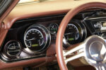 16 1963 Buick Riviera detailed view of Dakota Digital gauges behind a polished three spoke steering wheel