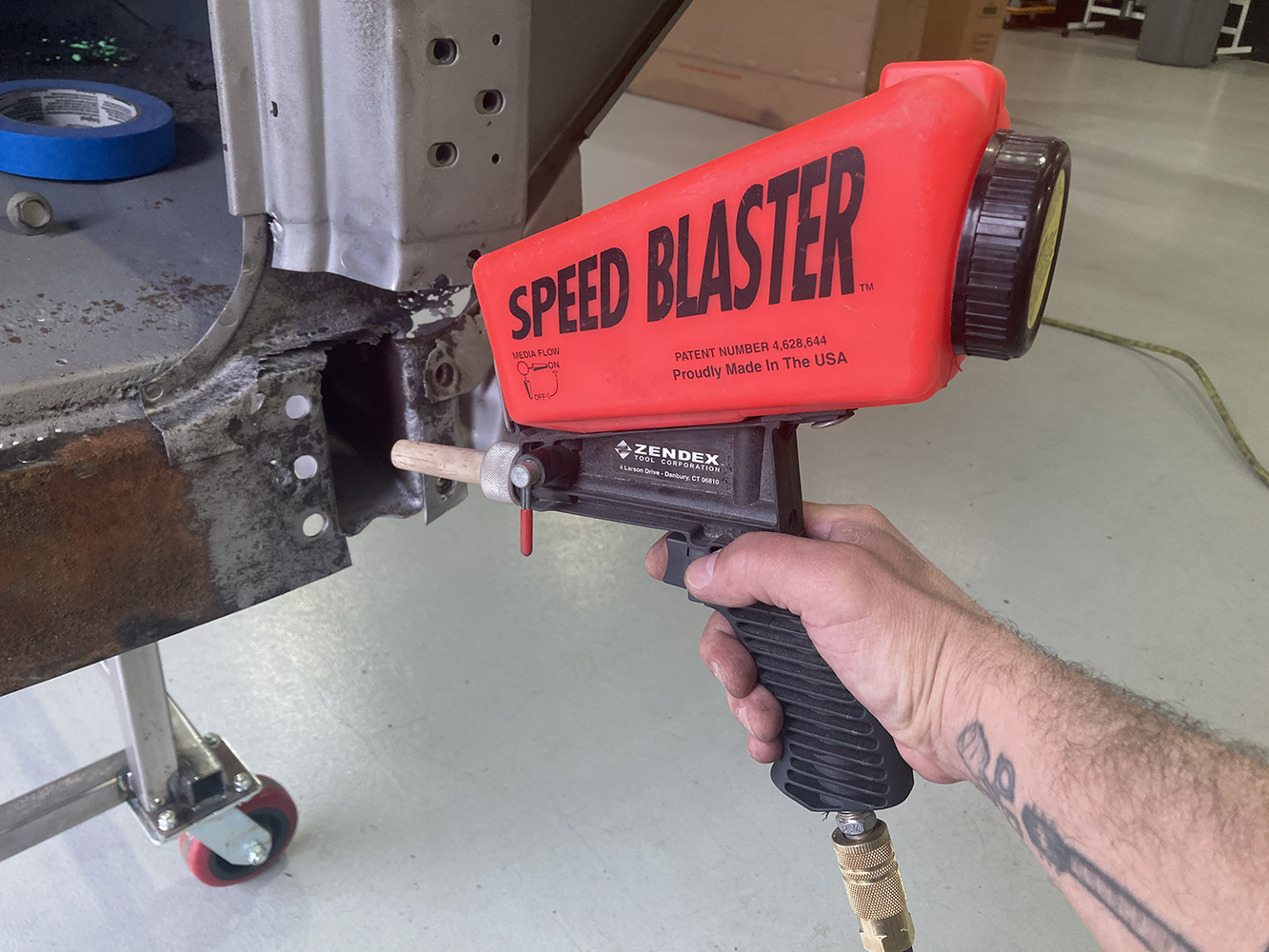 17 Sandblasting rusted metal to clean and prepare for welding