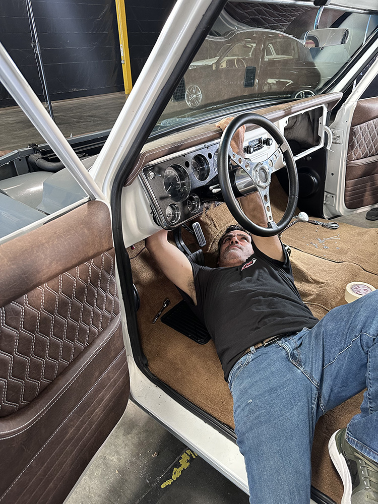 18 Technician working under dashboard for final adjustments
