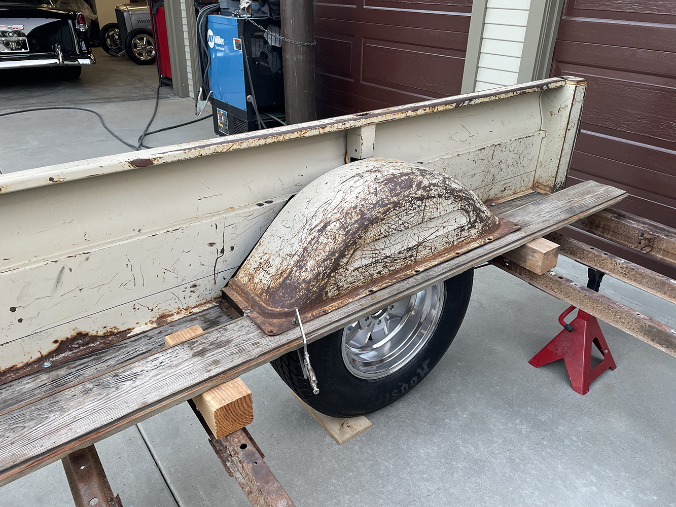 18 The original bed floor with worn wheel wells and rusted wood slats exposed