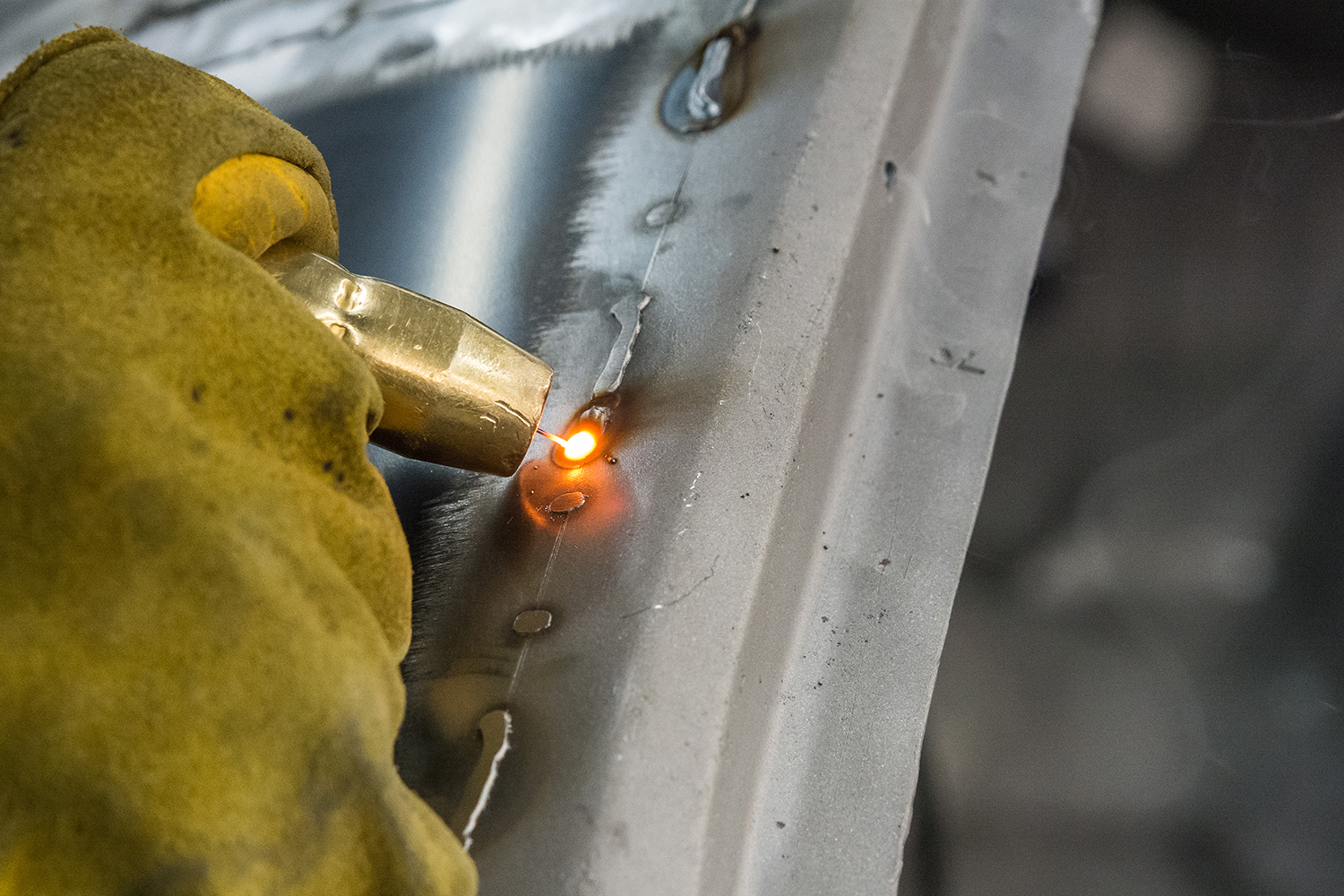 18 Welding torch fusing the quarter panel to the body structure