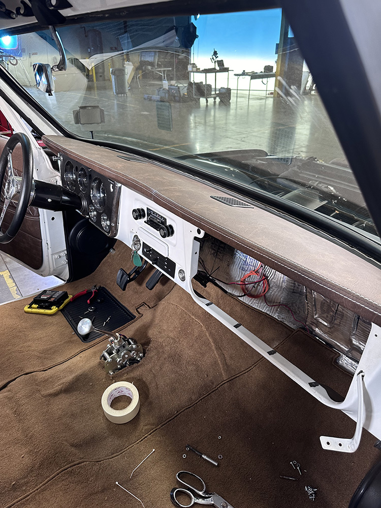 19 Completed dashboard with brown leather finish and classic chrome gauges