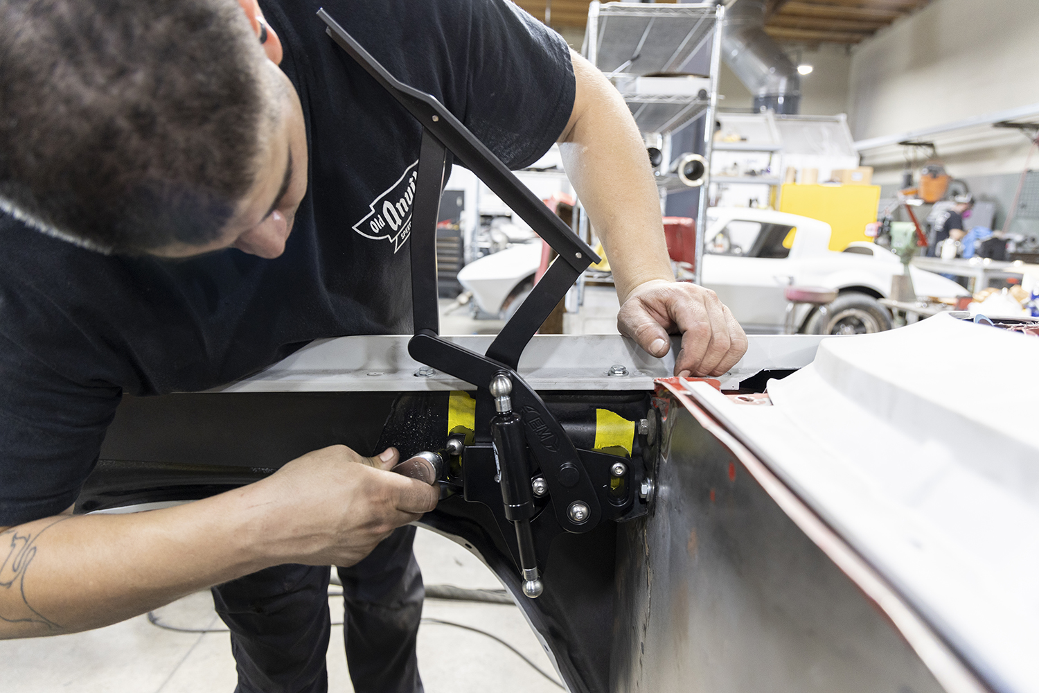19 Mechanic installing a billet trunk hinge on a 1962 Chevy Impala