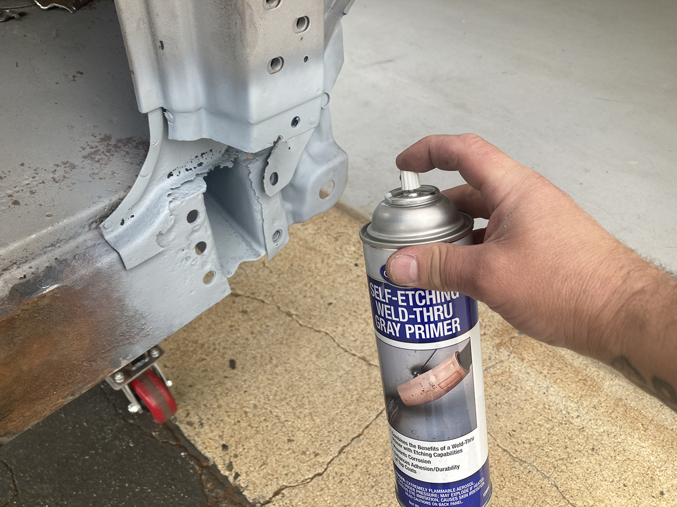 20 Self etching weld through primer being applied to the prepped metal surface