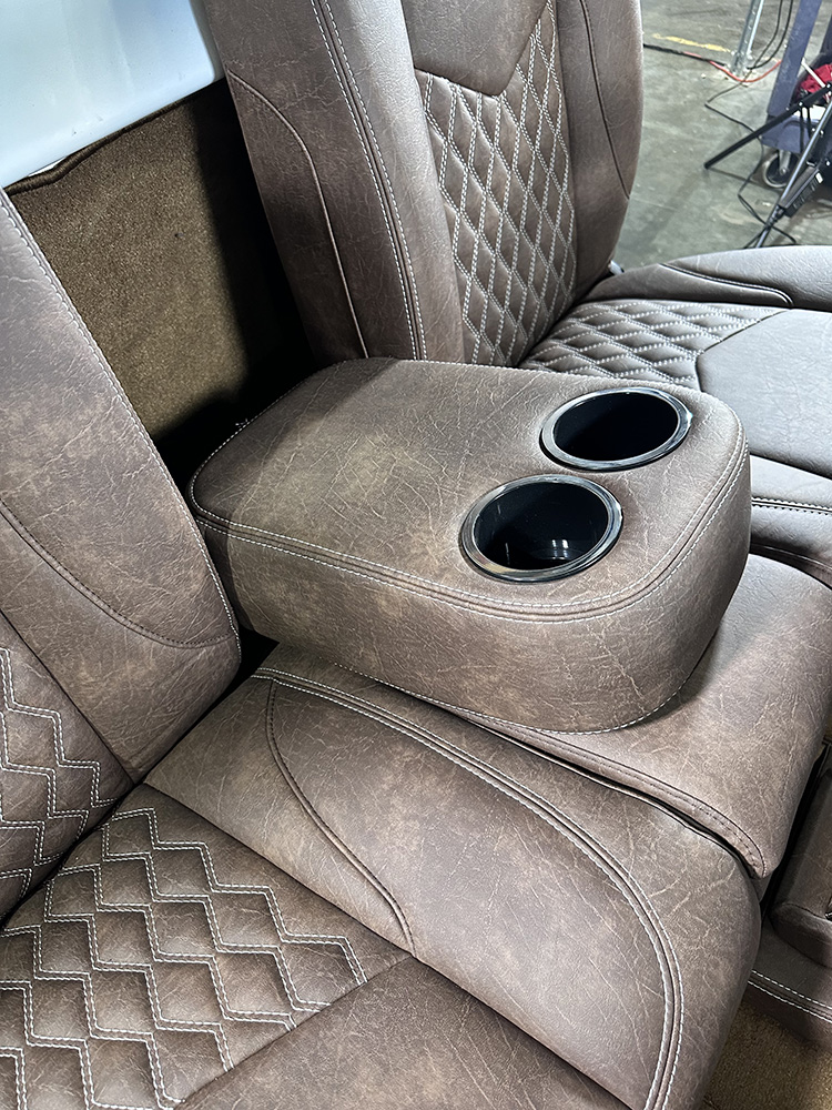 21 Close up of brown leather seat with integrated cup holders
