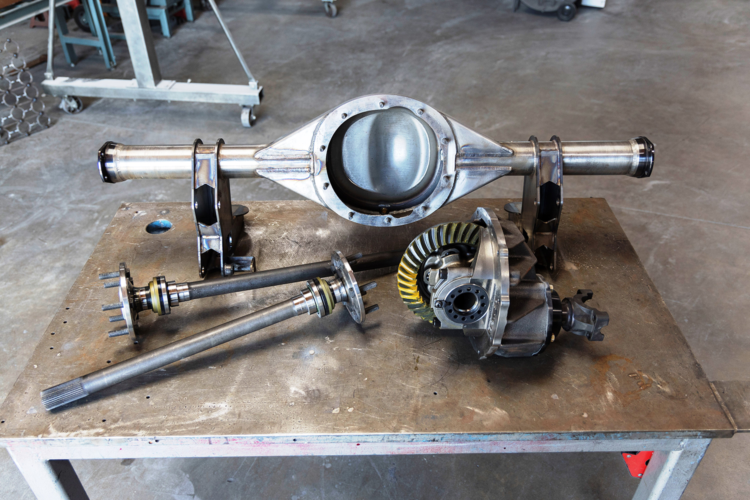 22 Disassembled Ford 9 inch rear end with axle shafts and third member laid out for assembly