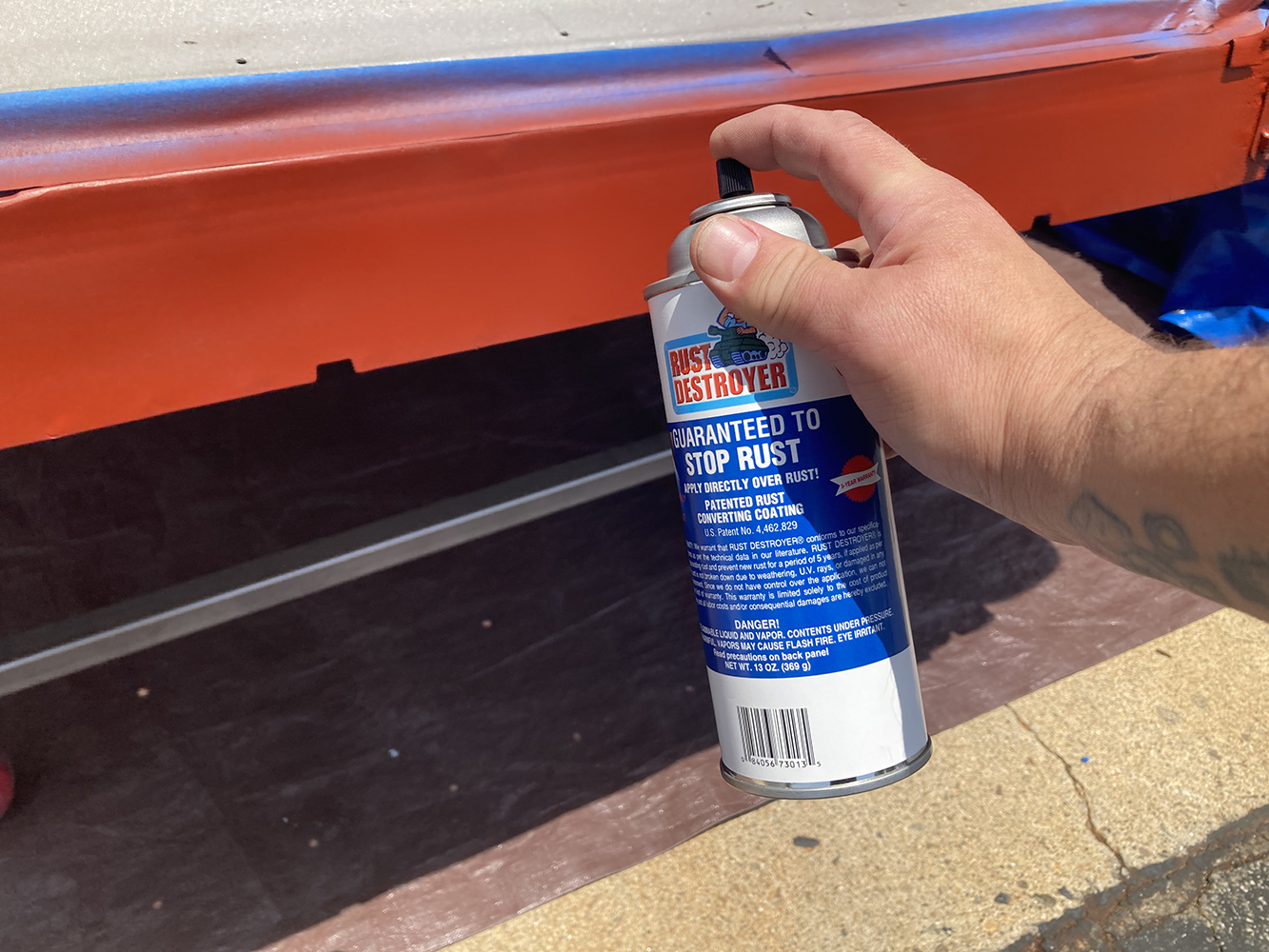 23 Rust converting primer being sprayed onto the rocker panel for protection