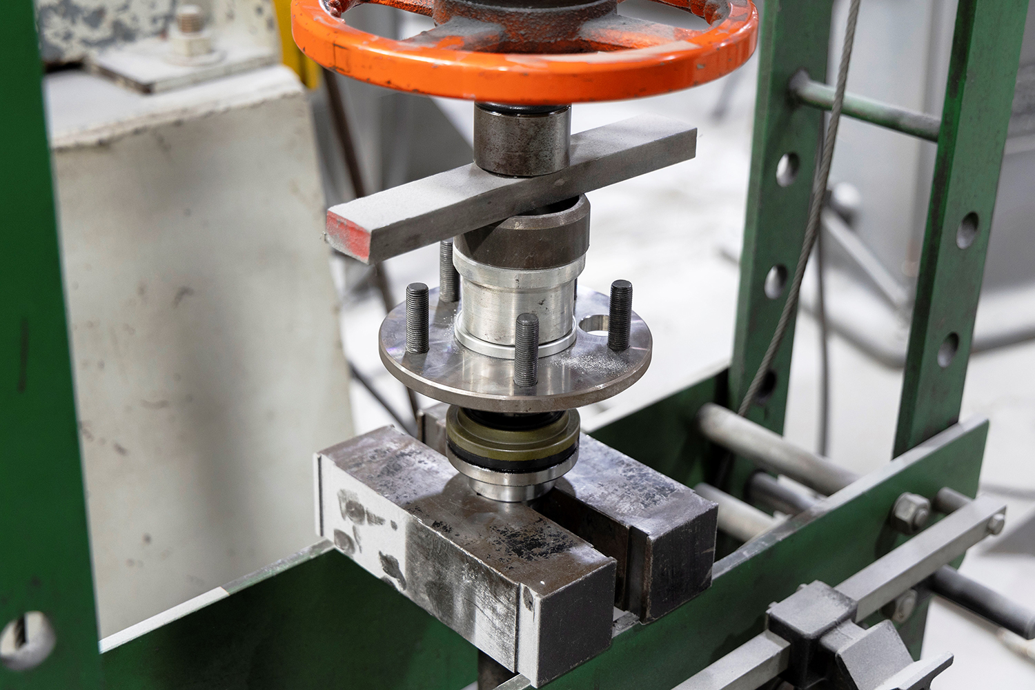 24 Pressing axle bearings onto a rear axle shaft using a hydraulic press for secure fitment