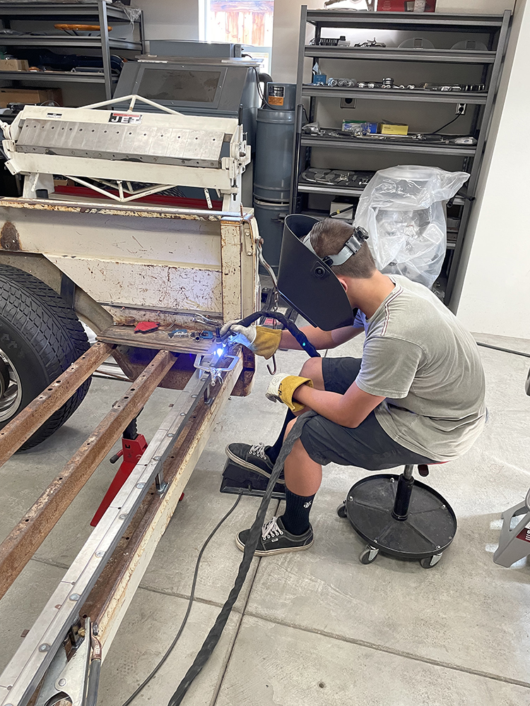 25 welder reinforcing the truck’s rear frame with new metal supports