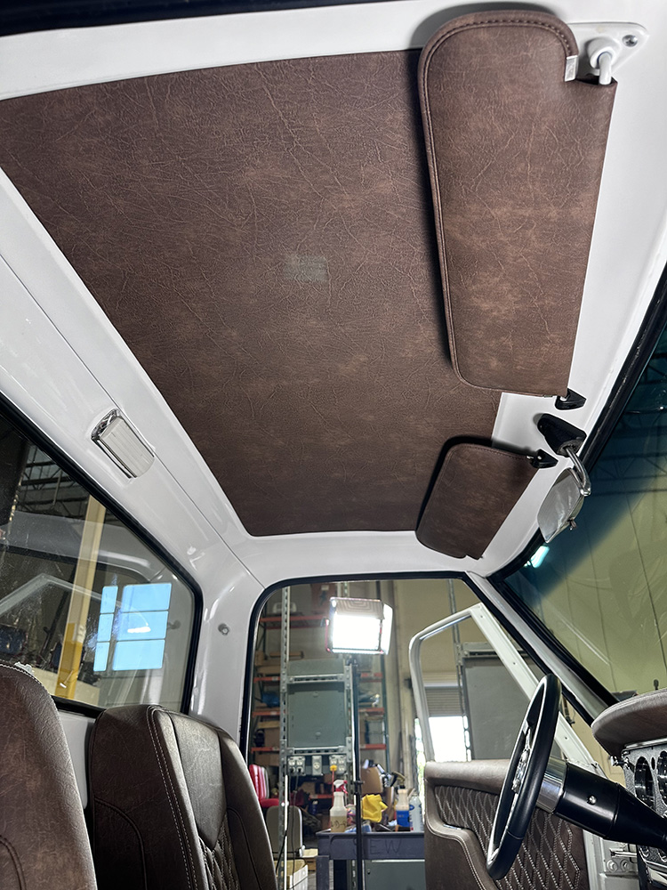 27 Fully installed headliner and visors complementing brown leather interior