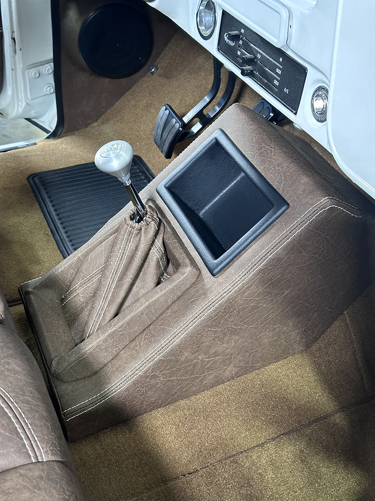 29 Completed center console with modern cup holder and stitched leather finish