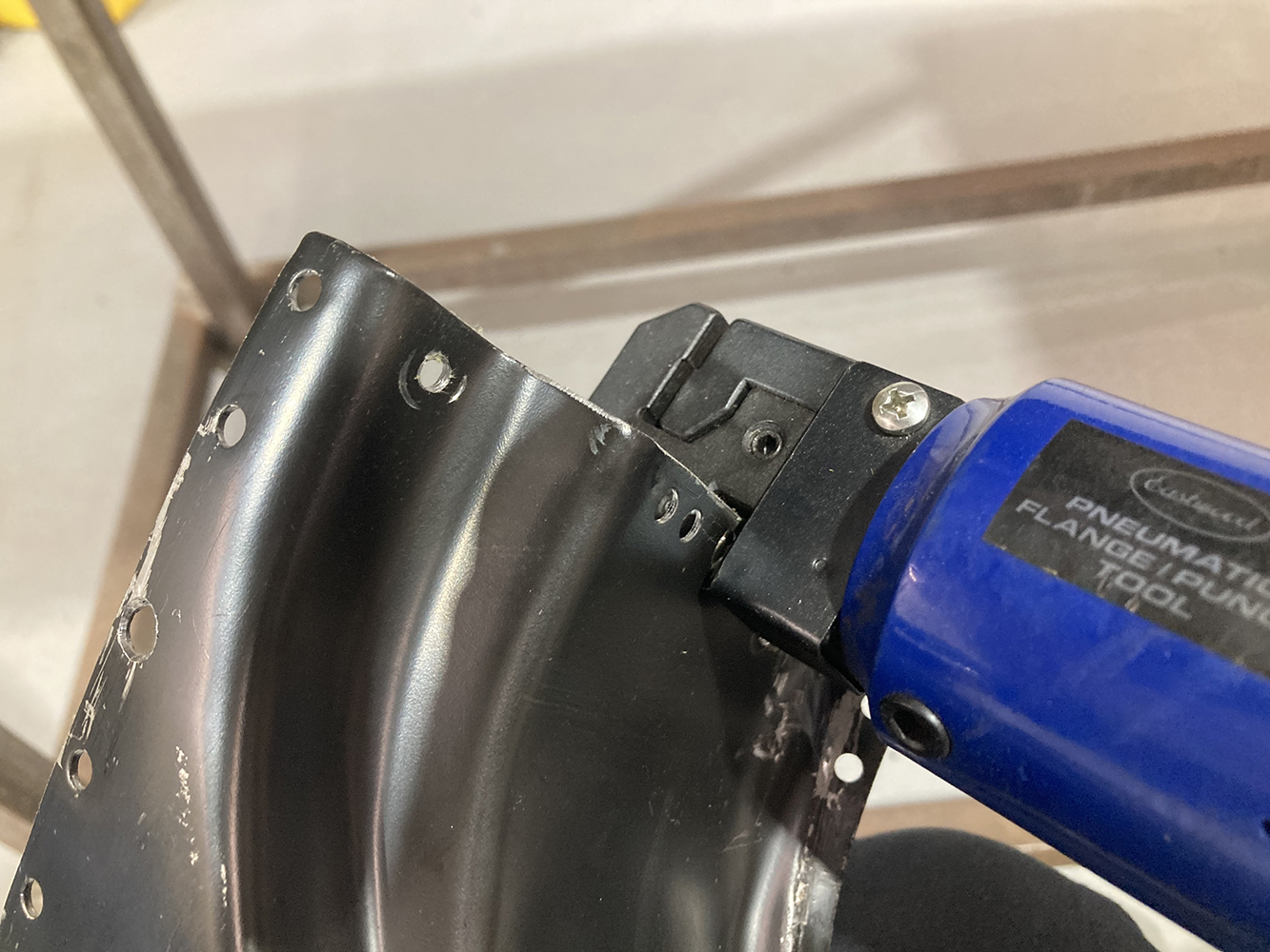 30 Pneumatic flange and hole punch tool creating spot weld holes on a patch panel