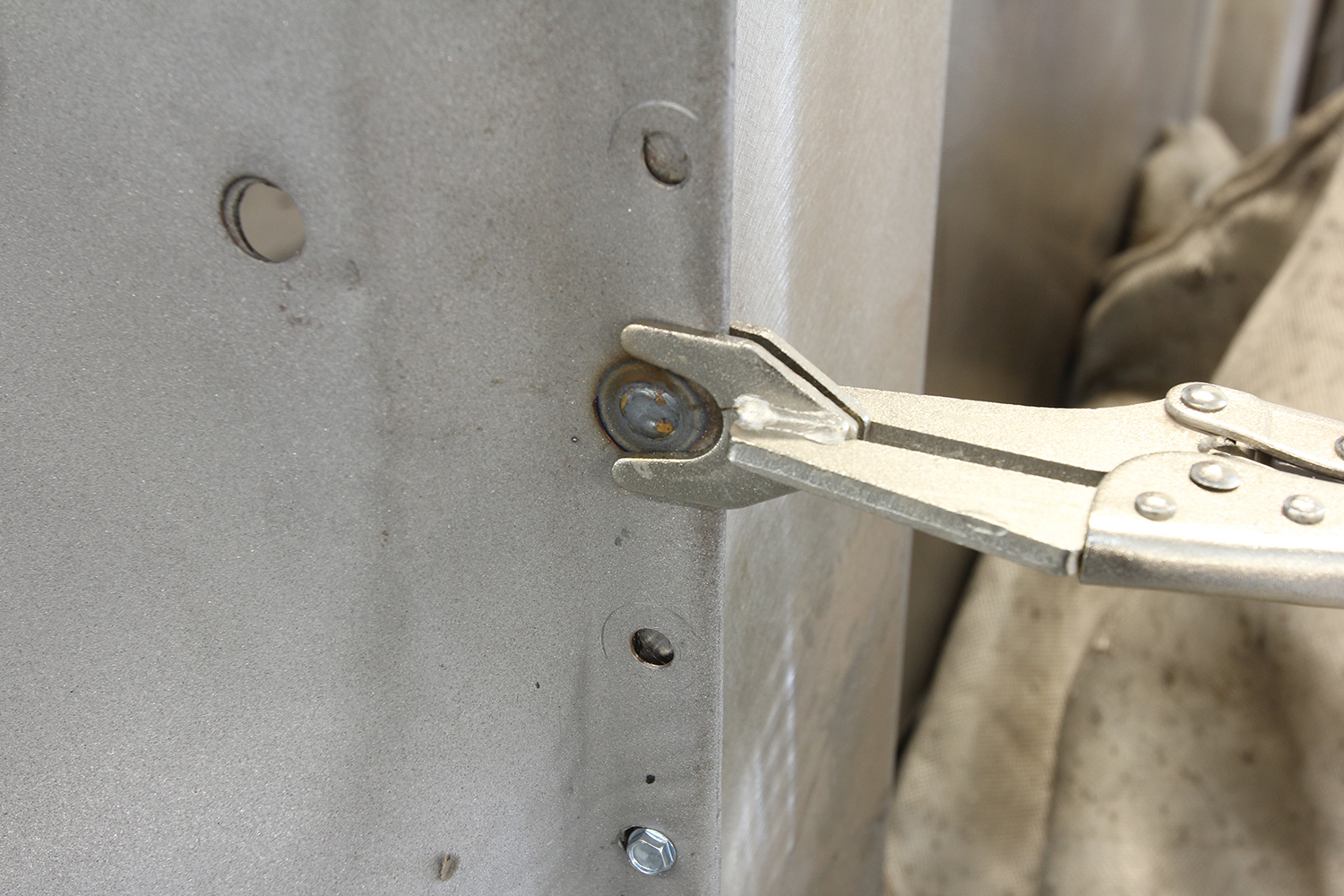 31 Locking pliers securing a plug weld in the cab structure