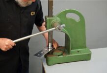 00 Using a manual arbor press to create dimples in a sheet metal panel