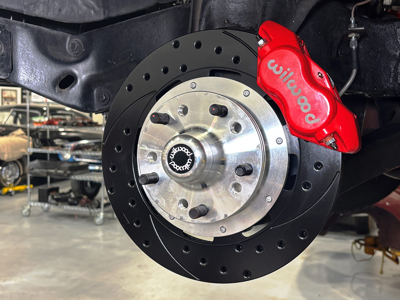 002 Wilwood red caliper with slotted and drilled rotor installed on a classic car