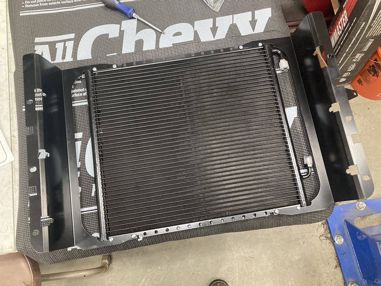003 AC condenser mounted on a workbench before installation