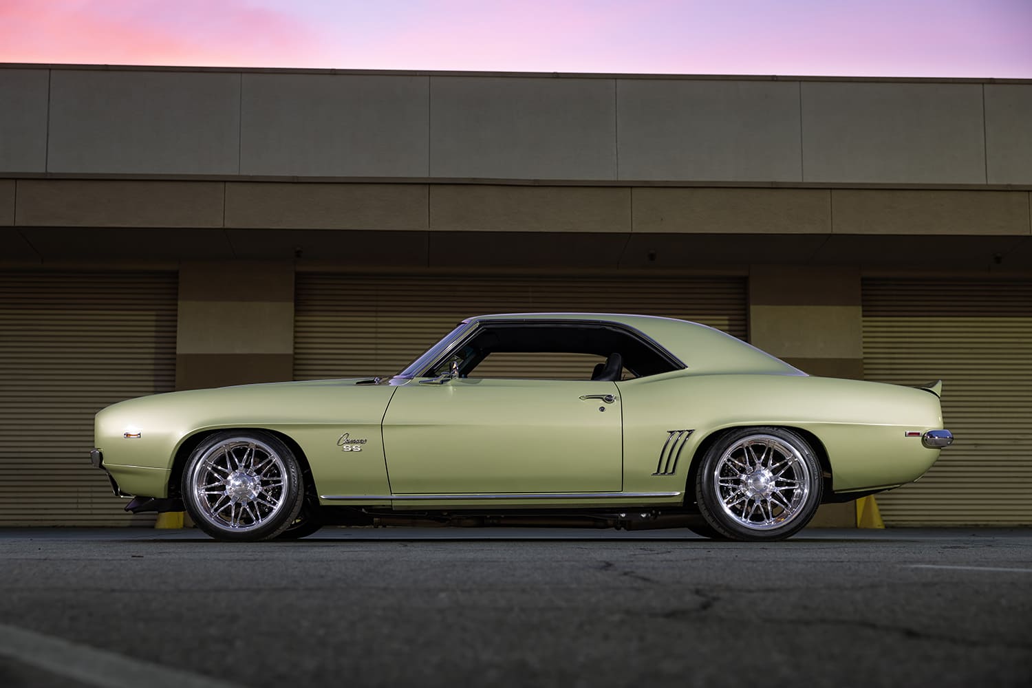 005 1969 Chevy Camaro SS side profile with chrome trim and staggered wheel setup