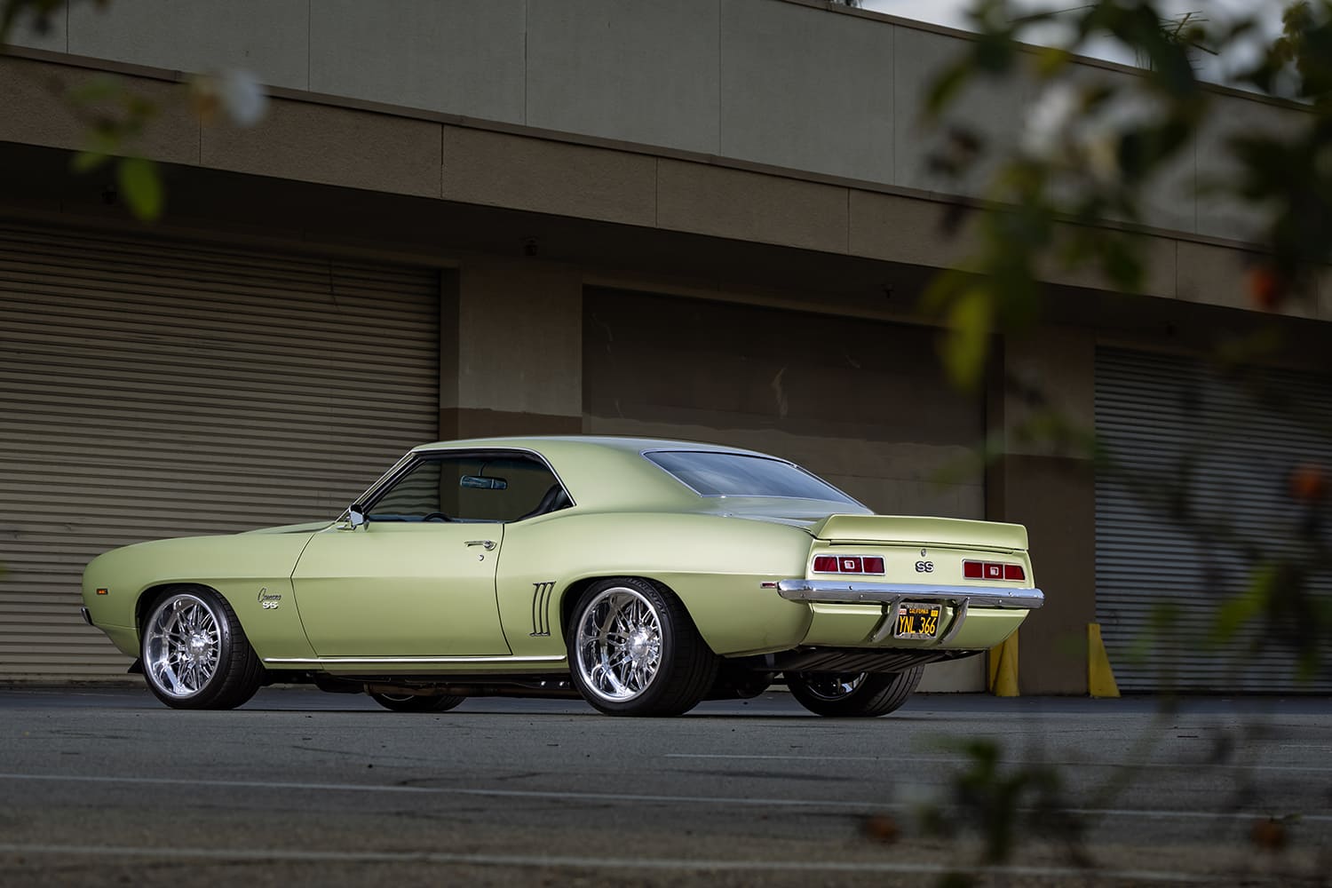 006 1969 Chevrolet Camaro SS rear three quarter view with factory style rear spoiler