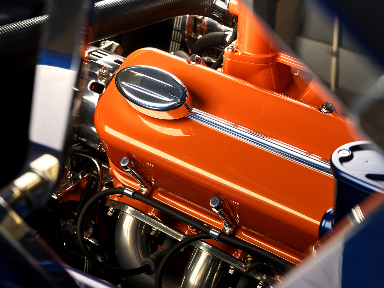 007 1966 Chevy Nova close up of the orange valve covers with chrome accents