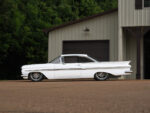 01 1959 Chevy Impala lowered on custom wheels with a clean white finish and sleek body lines