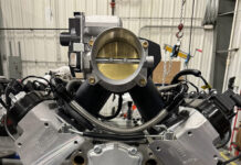 01 Assembled LS engine featuring BluePrint Engines valve covers billet front drive and a large throttle body on a tunnel ram intake