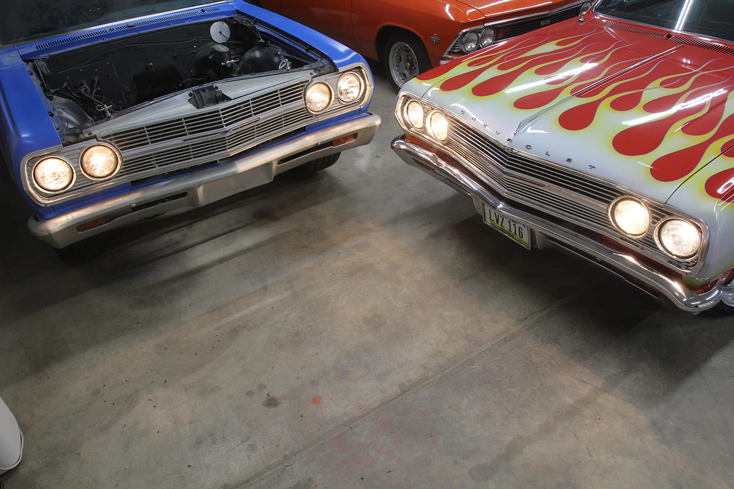 010 1965 Chevrolet El Camino pair with headlights on showcasing a flame painted and a blue project car