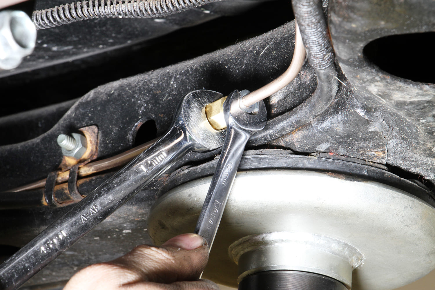 013 Tightening a brake line fitting under the car