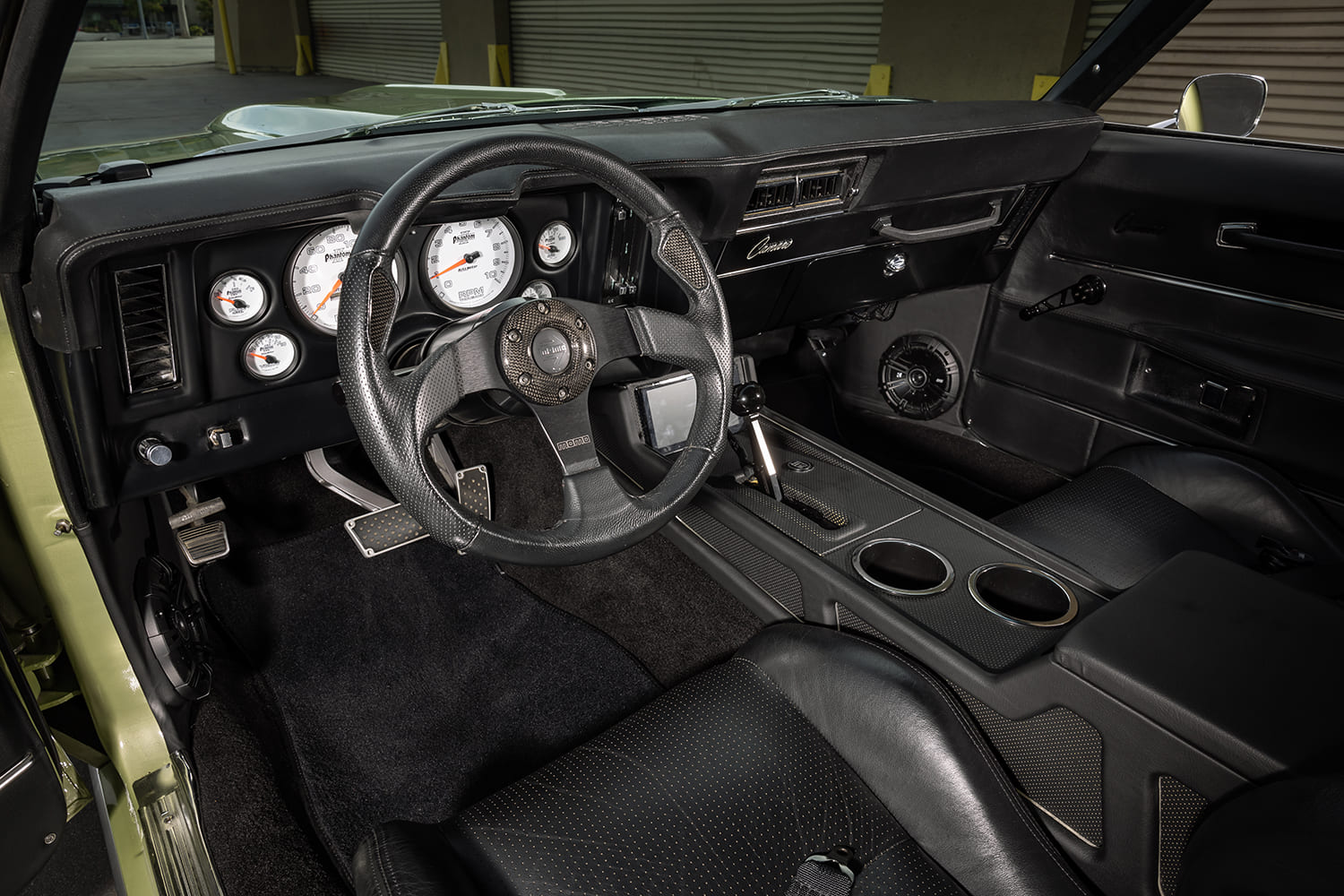 014 1969 Chevrolet Camaro SS interior featuring custom black leather seats and carbon fiber accents