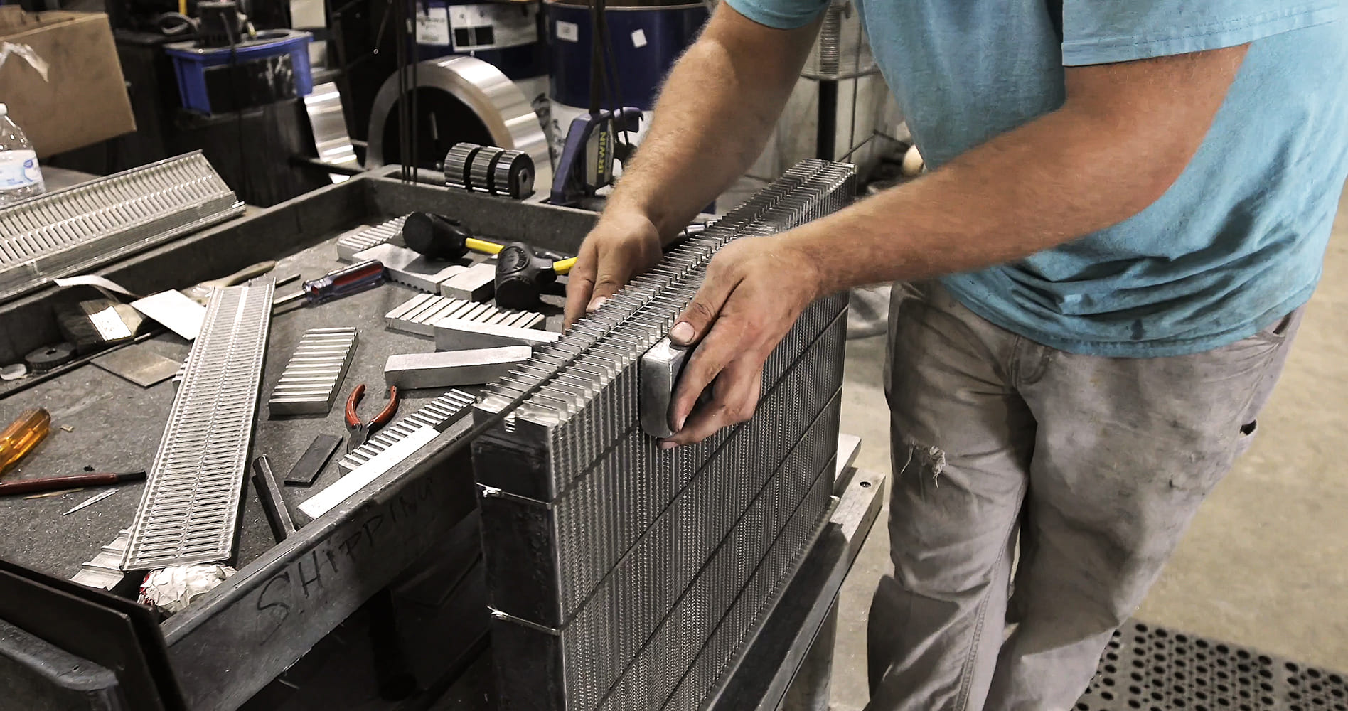 017 Worker assembling an all aluminum radiator core for high performance applications