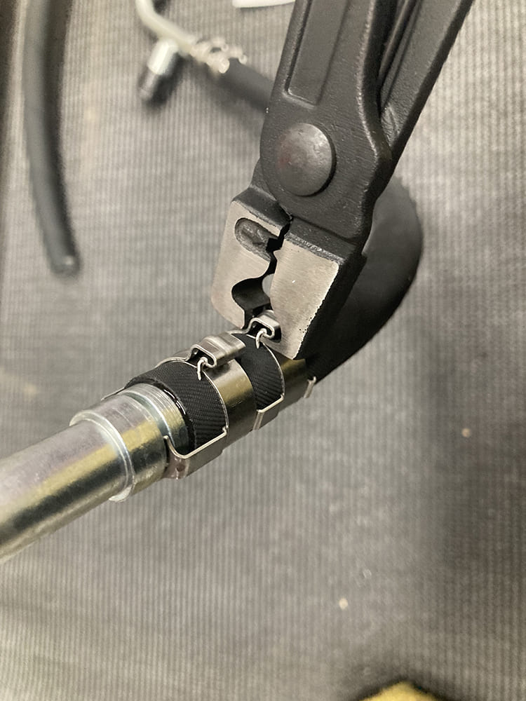 018 Crimping clamps secured around the AC hose fitting