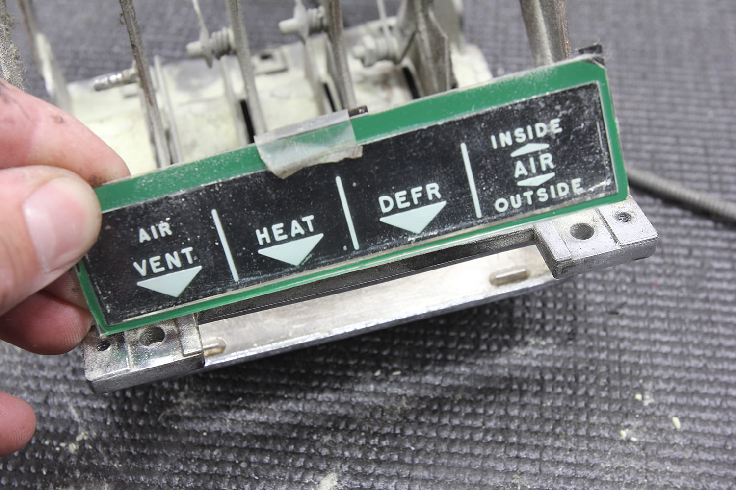 028 Removing the original control panel label for a new overlay