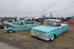 03 1966 Ford F 100 in turquoise patina with a Texaco logo sporting whitewalls and lowered suspension