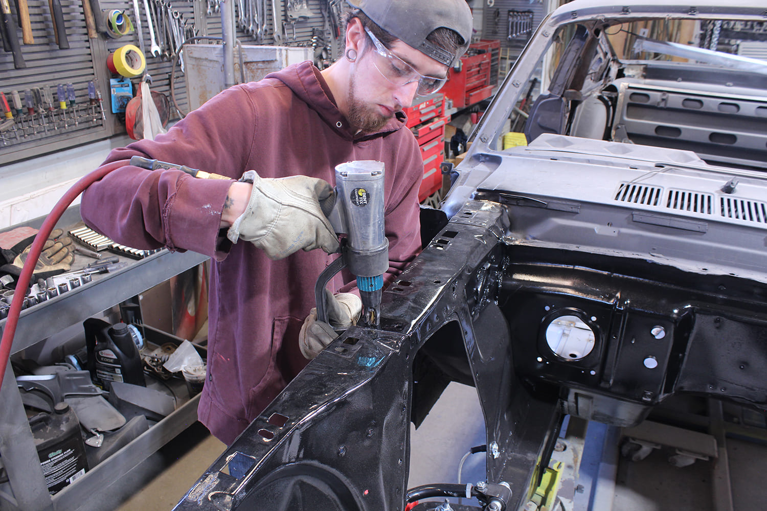 03 Technician drilling out spot welds on Ford Mustang radiator support using Blair equipment in a restoration shop
