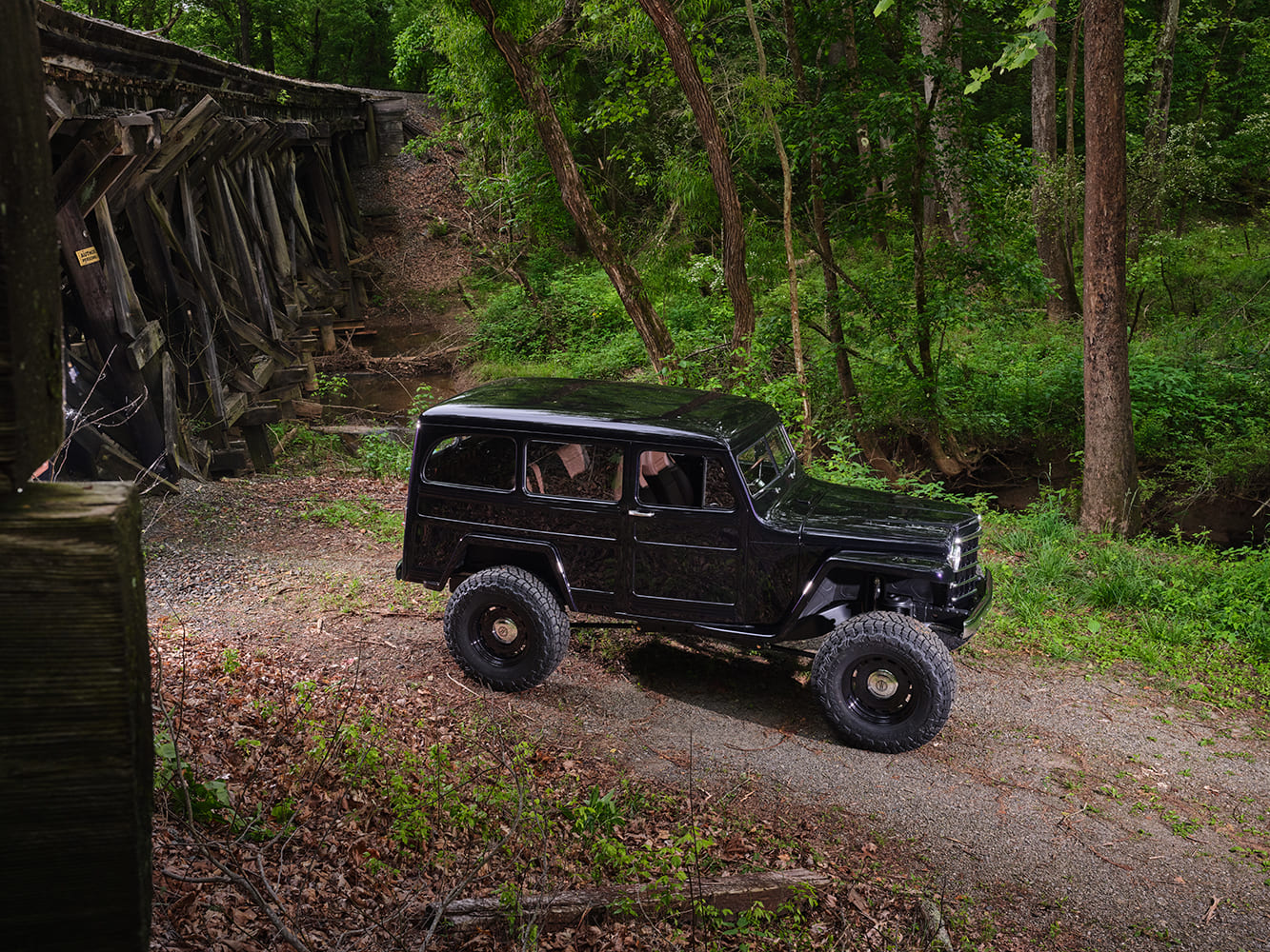 04 1950 Willys Jeep Station Wagon profile shot lifted stance black paint