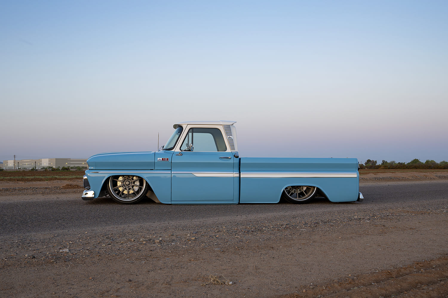 04 1965 Chevrolet C10 profile view slammed with polished wheels and trim