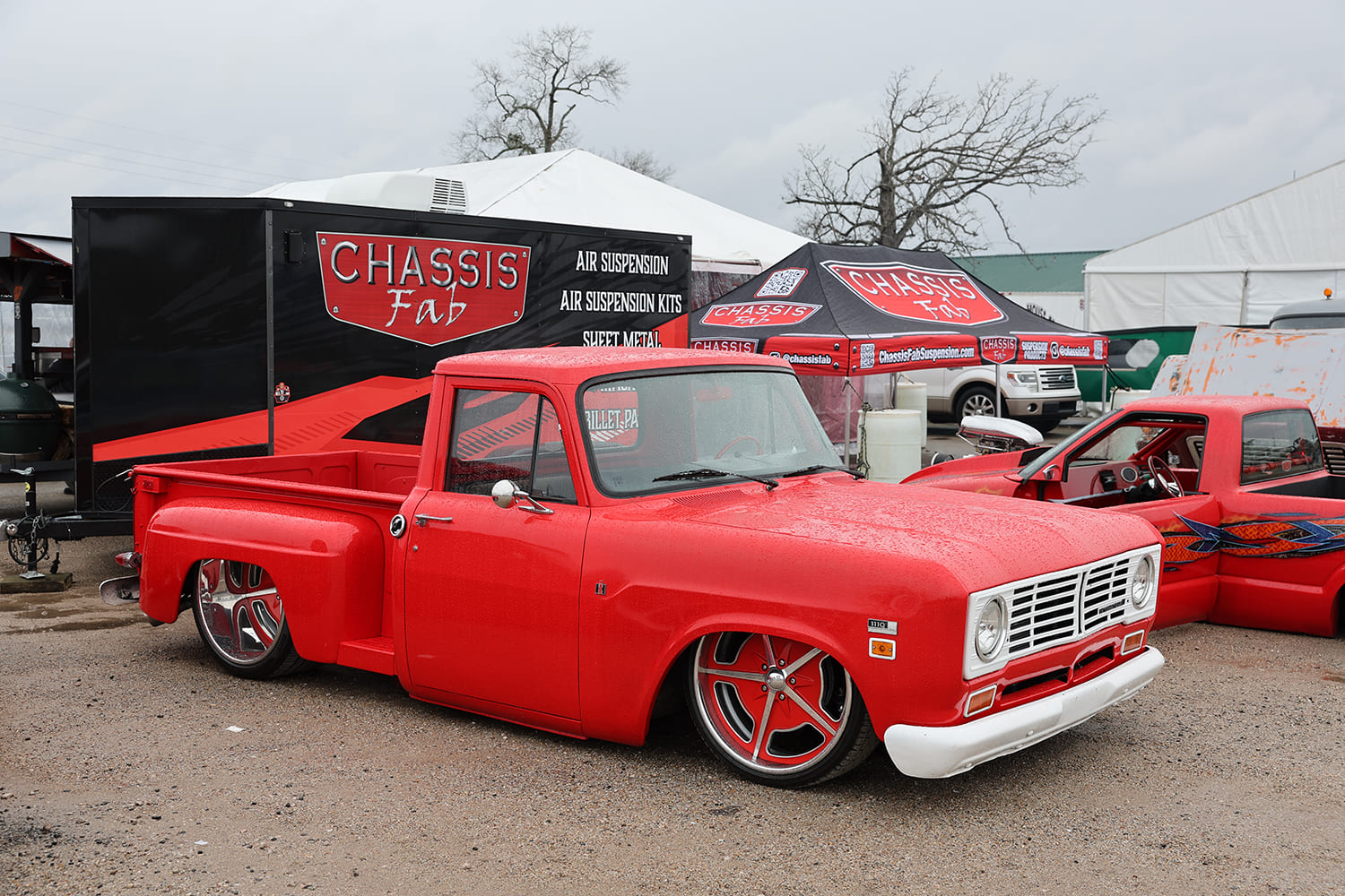 04 1973 International 1110 with red paint custom staggered billet wheels and full air ride setup by Chassis Fab