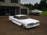 05 Aerial front three quarter view of 1959 Impala emphasizing sculpted fenders and dual antennas