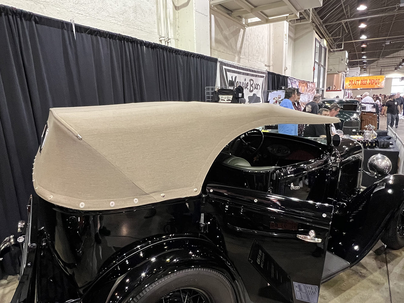 07 1932 Ford Phaeton displayed at indoor show with tan canvas custom top and snap detailing