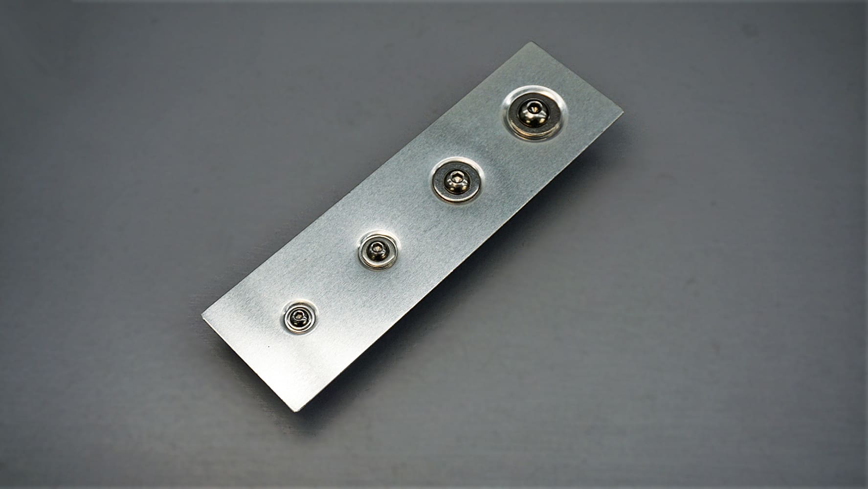 07 Different types of precision machined dimple dies laid out on a workbench