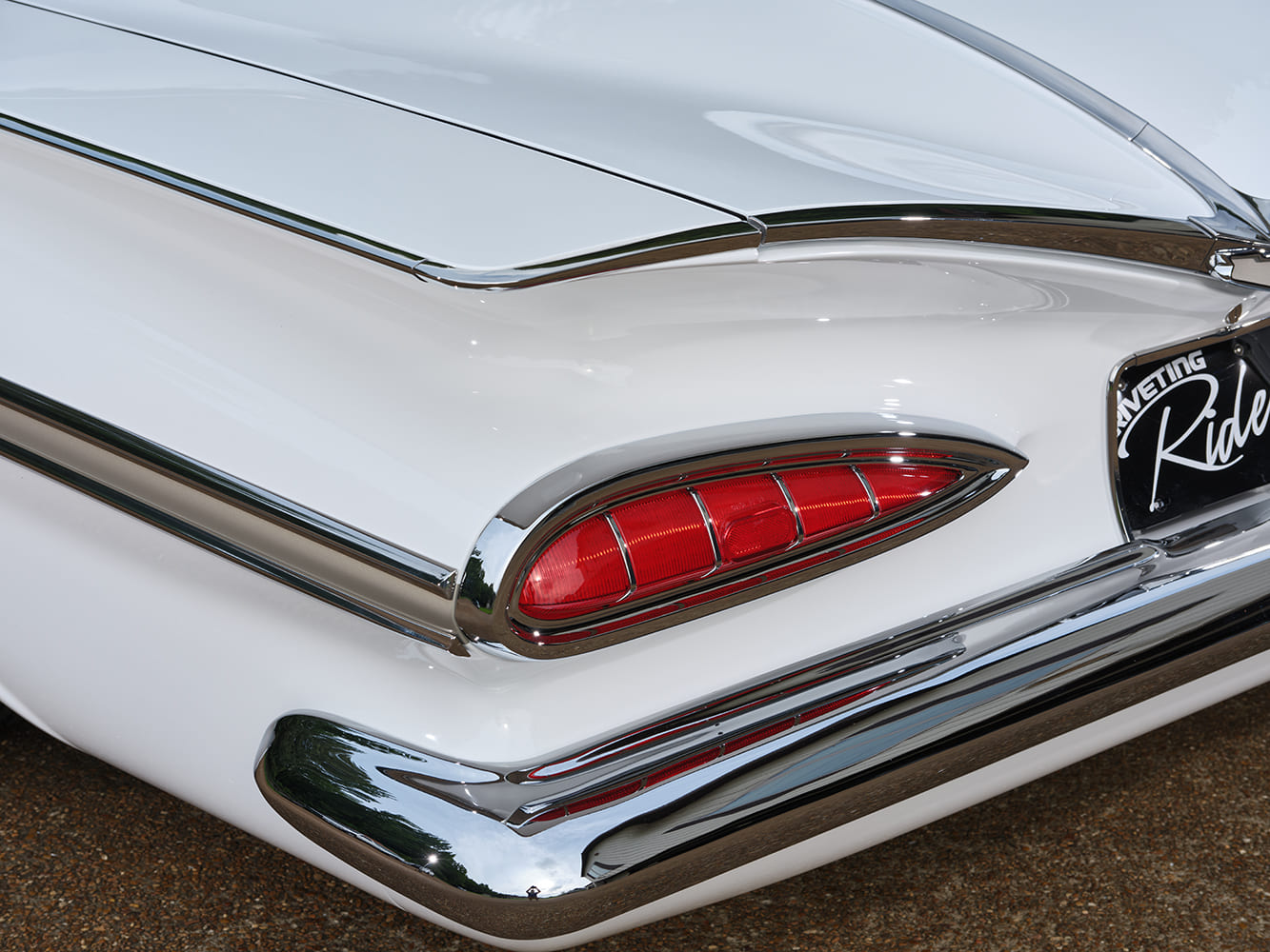 08 Close up of 1959 Chevy Impala taillight detailing chrome trim and vivid red lenses