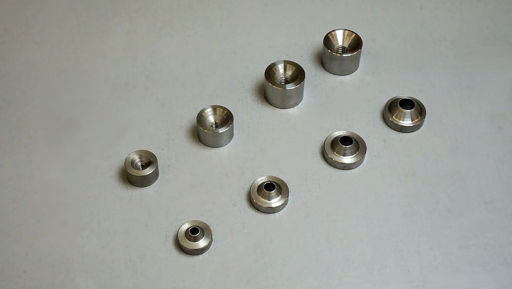 08 Demonstration of a completed metal piece with dimpled holes held for inspection