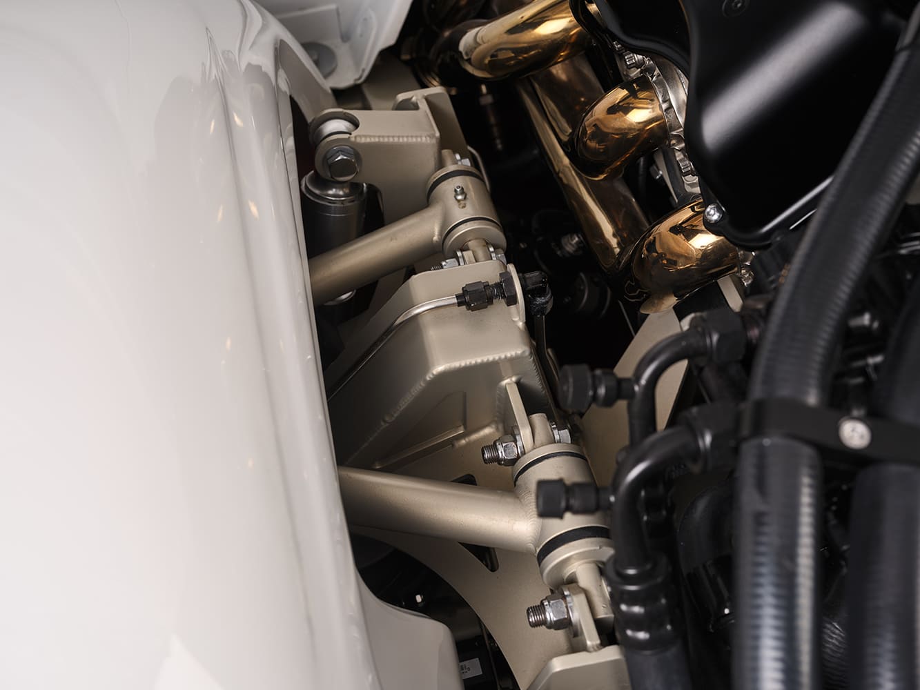 10 Close up of 1959 Impala’s suspension and engine bay showing tubular control arms and gold headers