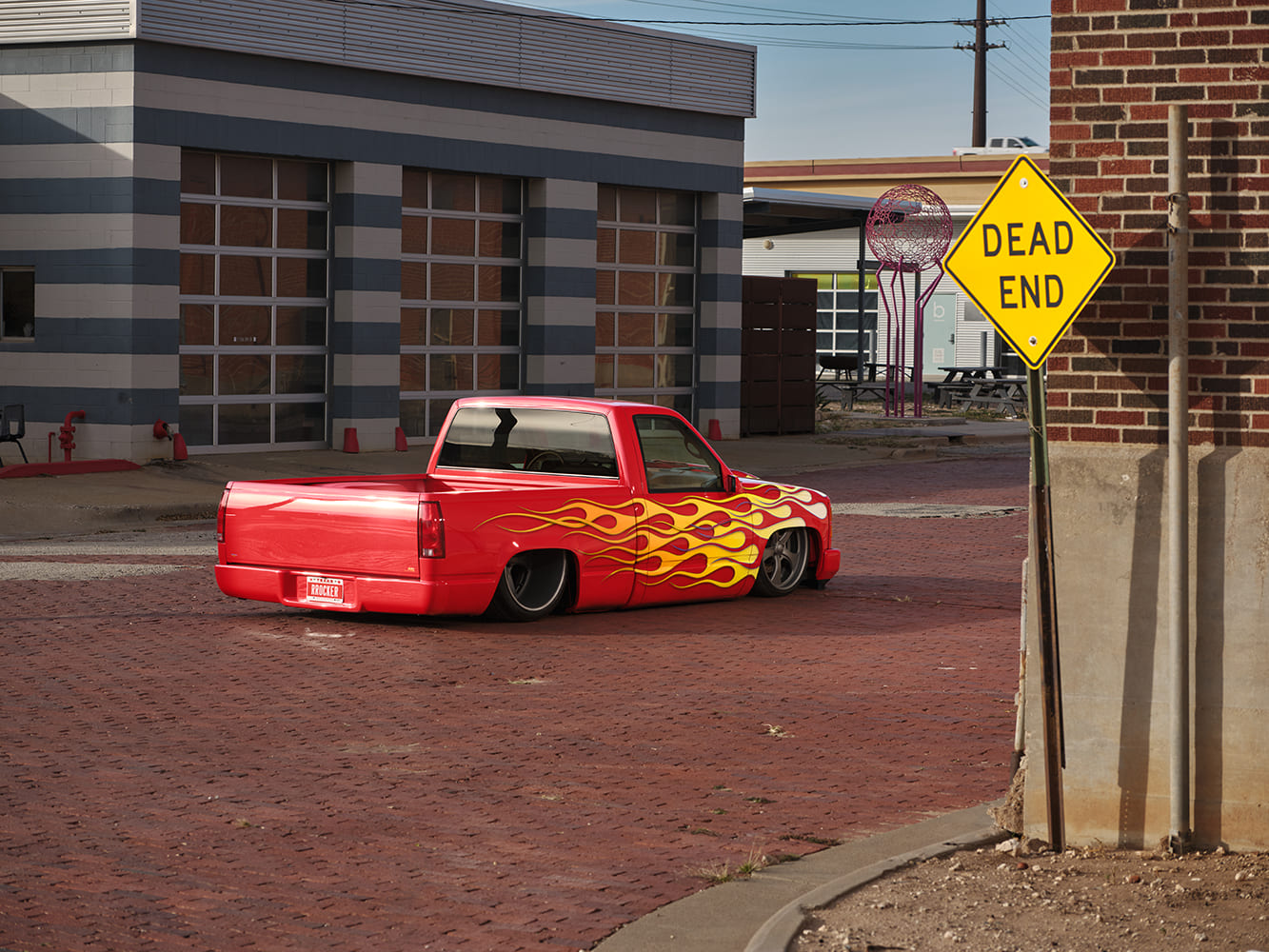 11 1996 Chevy C1500 with full tail shave and custom flame graphics sweeping into the bed