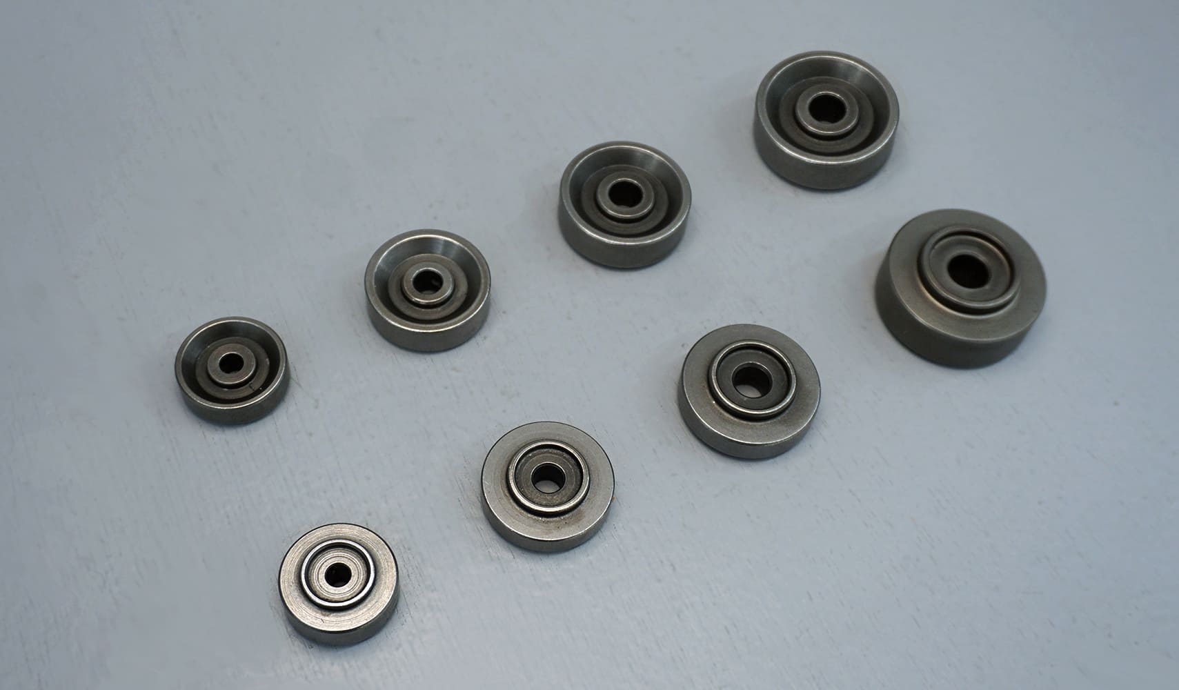 11 Various sizes of custom machined dimple dies arranged on a table