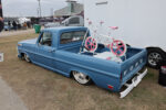 12 1970 Ford F100 in blue with billet wheels and a vintage BMX bike showcased in the bed