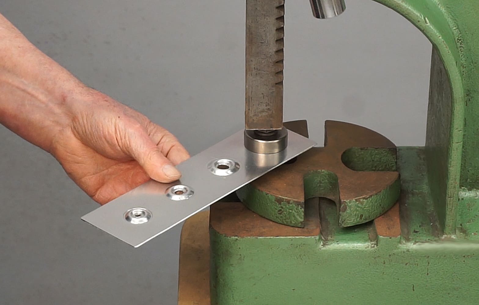 12 Metal panel being dimpled using an arbor press and specialized tooling