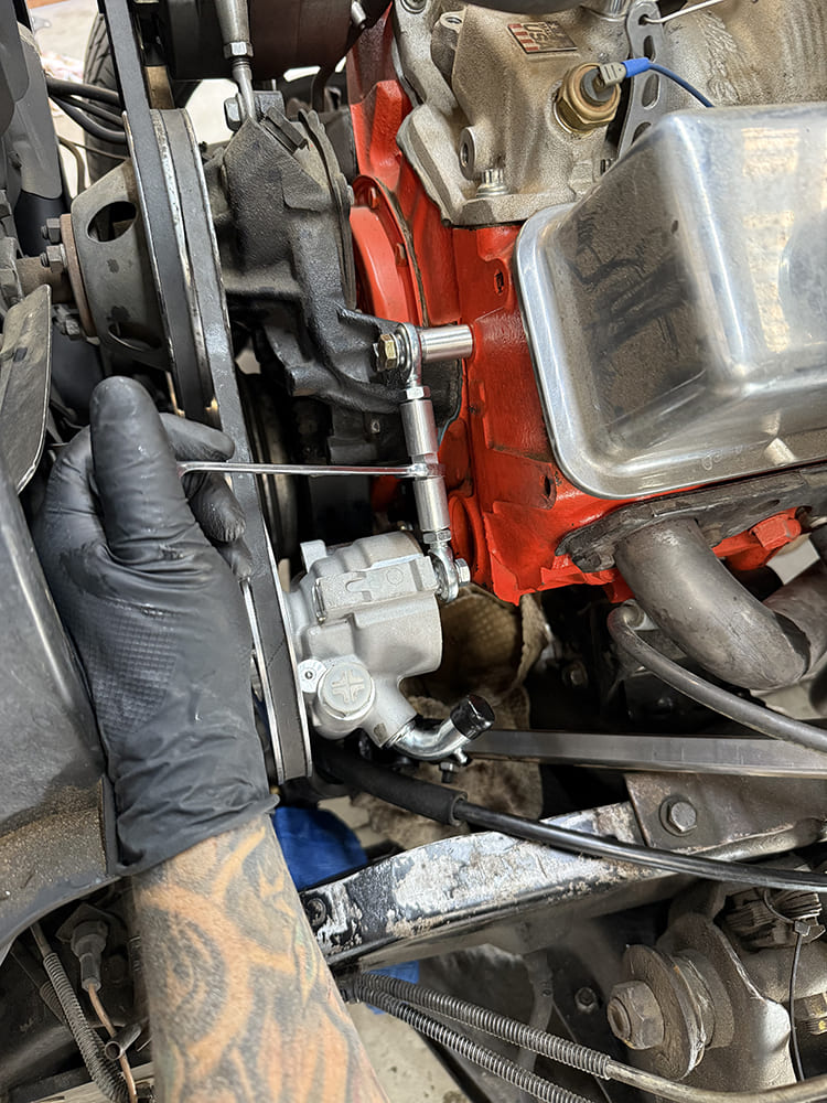 12 applying red threadlocker to billet pump tension rod bolts