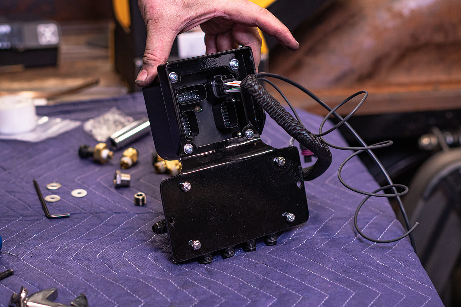 13 Electrical harness routed into the AccuAir ECU mounted to the VU4 manifold on padded workbench