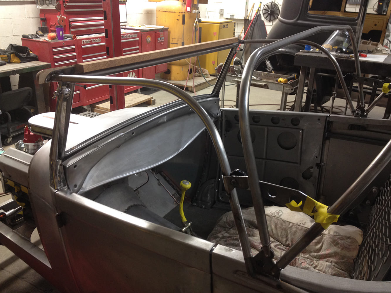 14 Metal rod framework fitted to early Ford body forming the structural skeleton for custom top bows